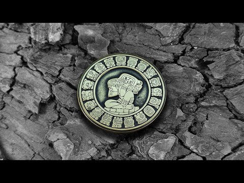 Video of a handcrafted Mayan brass coin showing 3D depth of engraving and aged antique finish on solid metal.