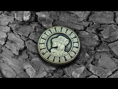 Video of a handcrafted Mayan brass coin showing 3D depth of engraving and aged antique finish on solid metal.