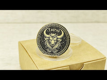 Personalized brass Taurus zodiac coin placed on a craft gift box, showcasing the durable metal texture and high-contrast professional patina treatment.