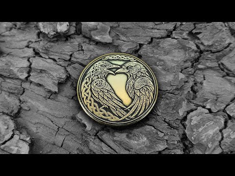 Video showcasing handcrafted brass Huginn and Muninn coin, 3D laser engraving detail and polished brass luster.