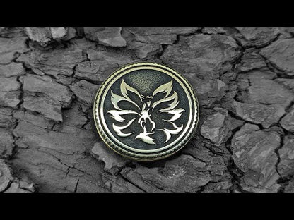 Nine-tailed fox Kitsune brass coin placed on dark wood bark background, showcasing golden metal contrast and fine engraving.
